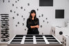 Risa Puno standing over her work The Privilege of Escape